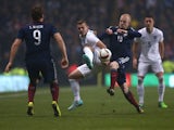 England's midfielder Jack Wilshere vies with Scotland's striker Steven Naismith during the international friendly football match between Scotland and England at Celtic Park in Glasgow, Scotland, on November 18, 2014