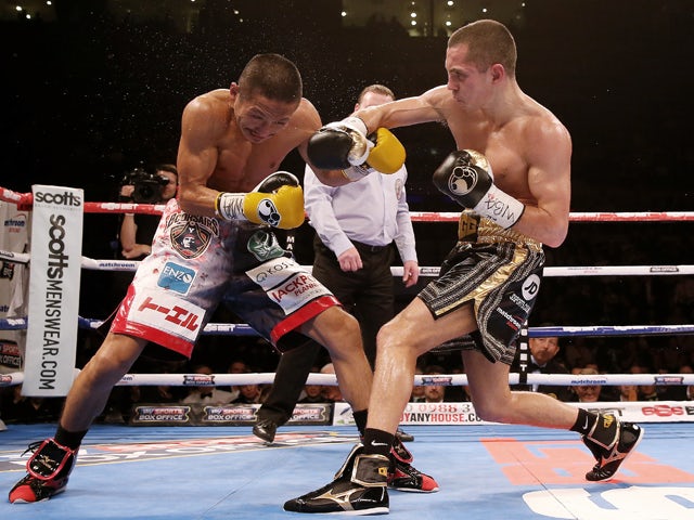 Scott Quigg in action with Hidenori Othake during their WBA World Super Bantamweight Championship bout at Liverpool Echo Arena on November 22, 2014