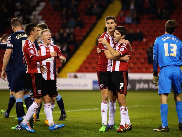 Chris Basham of Sheffield United congratulates Ryan Flynn on his goal during the FA Cup First Round Replay match between Sheffield United and Cewe Alexandra at Bramell Lane on November 18, 2014