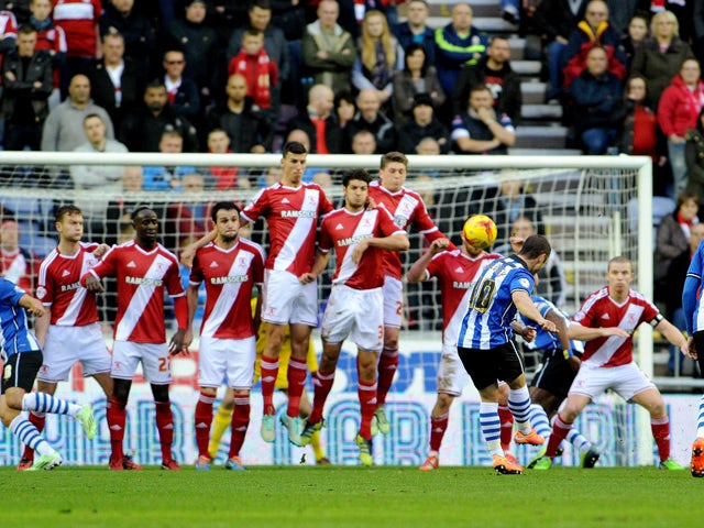 Shaun Maloney of Wigan Athletic scores the first goal during the Sky Bet Championship match between Wigan Athletic and Middlesbrough at DW Stadium on November 22, 2014