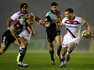 Will Cliff of Sale runs with the ball under pressure from Matt Hooper of Harlequins during the Aviva Premiership match on November 21, 2014