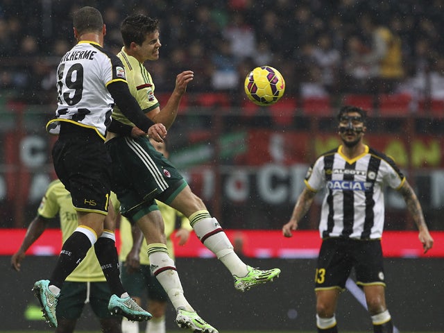 Marco Van Ginkel of AC Milan competes for the ball with Guillerme Dos Santos Torres of Udinese Calcio during the Serie A match between AC Milan and Udinese Calcio at Stadio Giuseppe Meazza on November 30, 2014