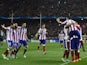 Atletico Madrid's players celebrate after scoring their fourth goal during the UEFA Champions League Group A football match Club Atletico de Madrid vs Olympiakos FC at the Vicente Calderon stadium in Madrid November 26, 2014