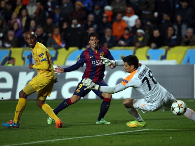 Barcelona's Uruguayan forward Luis Suarez scores past Apoel's Spanish goalkeeper Urko Pardo (R) during their UEFA Champions League football match at the Neo GSP Stadium in the Cypriot capital, Nicosia, on November 25, 2014