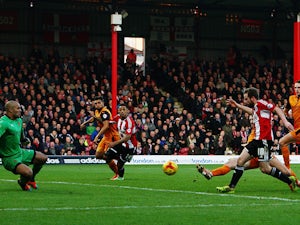 Alan Judge (#18) of Brentford shoots and scores past Carl Ikem the Wolverhampton Wanderers goalkeeper during the Sky Bet Championship match between Brentford and Wolverhampton Wanderers at Griffin Park on November 29, 2014
