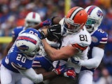 Jim Dray #81 of the Cleveland Browns is tackled by Aaron Williams #23, Corey Graham #20 and Preston Brown #52 of the Buffalo Bills during the first half at Ralph Wilson Stadium on November 30, 2014