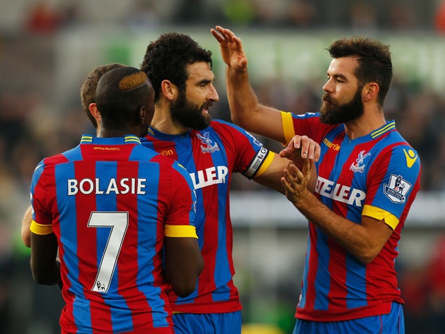 Mile Jedinak of Crystal Palace celebrates with team mates as he scores their first and equalising goal from a penalty during the Barclays Premier League match between Swansea City and Crystal Palace at Liberty Stadium on November 29, 2014