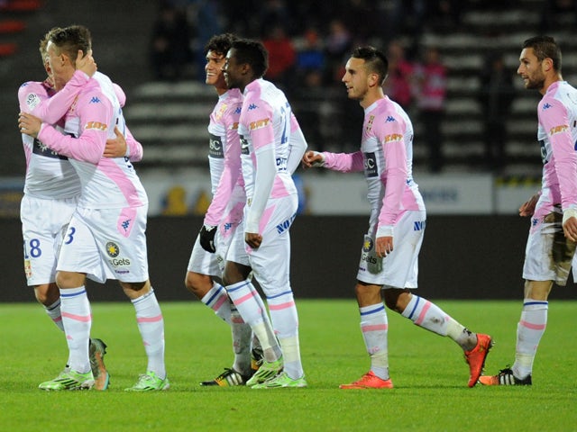 Evian's Danish midfielder Daniel Wass celebrates with teammates after scoring during the French L1 football match Evian (ETGFC) against Guingamp (EAG) on November 30, 2014