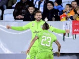 Juventus' forward Fernando Llorente celebrates with his teammate midfielder Arturo Vidal after scoring a goal the UEFA Champions League group A football match Malmo FF vs Juventus at the Swedbank Stadion in Malmo, Sweden on November 26, 2014