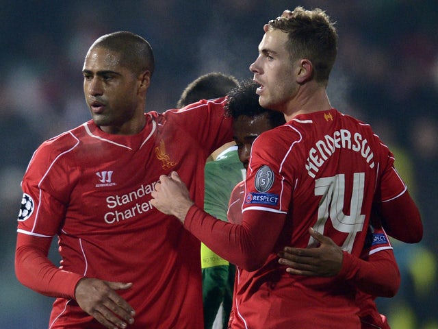 Liverpool's English midfielder Jordan Henderson celebrates with teamates after scoring a goal on November 26, 2014