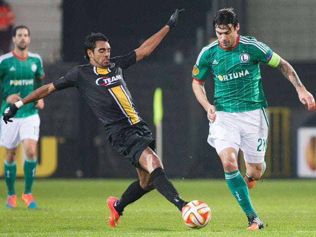 Lokeren's Sergio Junior Dutra and Legia's Ivica Vrdoljak fight for the ball during the UEFA Europa League Group L football match between KSC Lokeren OVL and Legia Warszawa on November 27, 2014