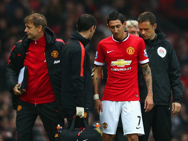 Injured Angel di Maria of Manchester United receives treatment during the Barclays Premier League match between Manchester United and Hull City at Old Trafford on November 29, 2014 