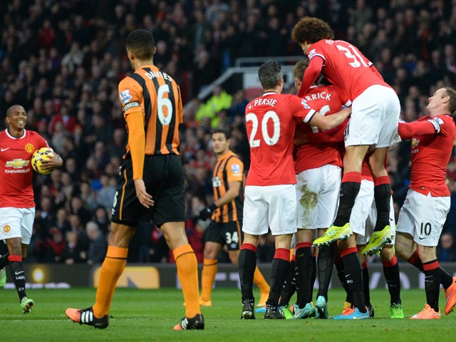 Manchester United players congratulate Manchester United's English defender Chris Smalling after he scores their opening goal of the English Premier League football match between Manchester United and Hull City at Old Trafford in Manchester, north west En