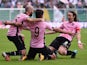 Paulo Dybala of Palermo celebrates with Enzo Maresca and Edgar Barreto after scoring the opening goal during the Serie A match between US Citta di Palermo and Parma FC at Stadio Renzo Barbera on November 30, 2014