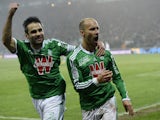 Saint-Etienne's French midfielder Renaud Cohade is congratuled by teammate St Etienne's French defender Loïc Perrin after scoring during the French L1 football match AS Saint-Etienne (ASSE) vs Lyon (OL) on November 30, 2014