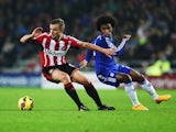 Sunderland's English midfielder Lee Cattermole vies with Chelseas Brazilian midfielder Willian during the English Premier League football match between Sunderland and Chelsea at The Stadium of Light in Sunderland, north east England on November 29, 2014