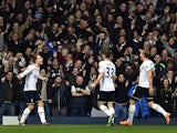 Tottenham Hotspur's Danish midfielder Christian Eriksen celebrates with teammates after scoring their first goal during the English Premier League football match between Tottenham Hotspur and Everton at White Hart Lane in north London on November 30, 2014