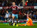 Aaron Cresswell of West Ham celebrates scoring opening goal past Robert Elliot of Newcastle United during the Barclays Premier League match between West Ham United and Newcastle United at Boleyn Ground on November 29, 2014