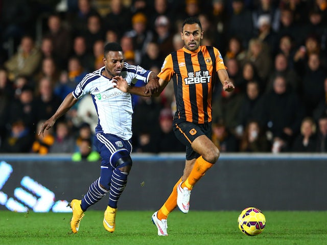 Ahmed Elmohamady of Hull City is challenged by Stephane Sessegnon of West Brom during the Barclays Premier League match on December 6, 2014