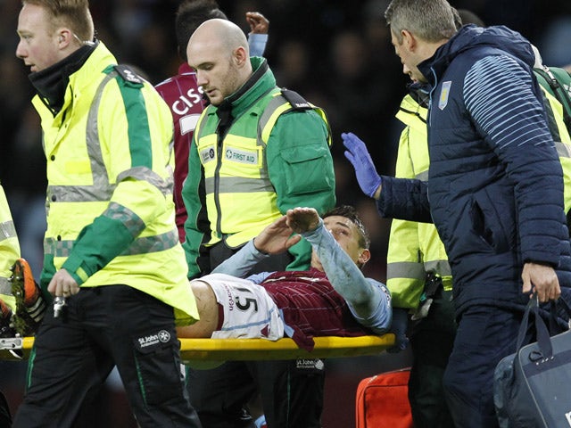 Aston Villa's English midfielder Ashley Westwood is stretchered off injured during the English Premier League football match between Aston Villa and Leicester City at Villa Park in Birmingham, central England on December 7, 2014