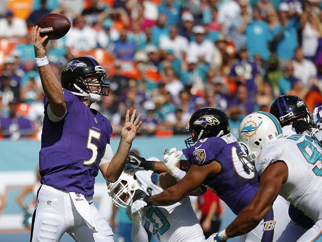 Quarterback Joe Flacco #5 of the Baltimore Ravens throws against the Miami Dolphins in the first quarter during a game at Sun Life Stadium on December 7, 2014
