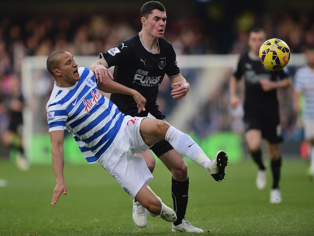 Bobby Zamora of QPR is challenged by Michael Keane of Burnley during the Barclays Premier League match on December 6, 2014