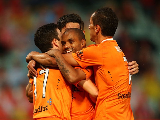 Henrique of the Roar celebrates with team mates after scoring a goal during the round four A-League match between the Western Sydney Wanderers and Brisbane Roar at Pirtek Stadium on December 3, 2014