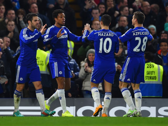 Loic Remy of Chelsea celebrates scoring their third goal with Cesc Fabregas, Eden Hazard and Cesar Azpilicueta of Chelsea during the Barclays Premier League match between Chelsea and Tottenham Hotspur at Stamford Bridge on December 3, 2014