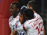 Lyon's French midfielder Corentin Tolisso (C) is congratuled by teamates after scoring during the French League football match Olympique Lyonnais against Stade de Reims on December 4, 2014