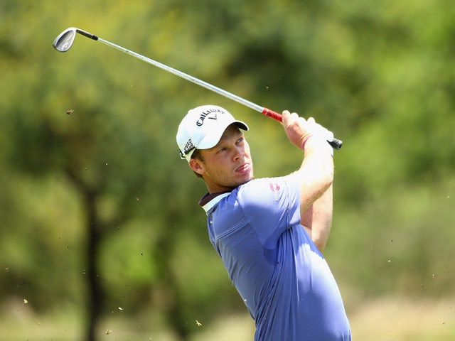 Danny Willett of England plays into the 1st green during the final round of the Nedbank Golf Challenge at the Gary Player Country Club on December 7, 2014