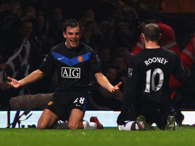 Darron Gibson of Manchester United celebrates with team mate Wayne Rooney (10) as he scores their second goal during the Barclays Premier League match against West Ham on December 5, 2014