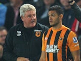 New Hull City signing Hatem Ben Arfa gets some advice from manager Steve Bruce before coming on for his debut on September 15, 2014