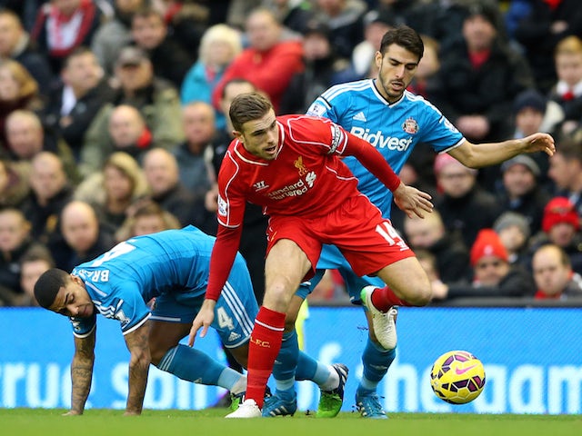 Jordan Henderson of Liverpool battles for the ball with Jordi Gomez and Liam Bridcutt of Sunderland during the Barclays Premier League match on December 6, 2014