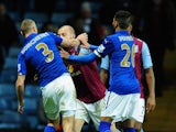 Alan Hutton of Villa clashes with Paul Konchesky of Leicester before Konchesky gets a red card during the Barclays Premier League match between Aston Villa and Leicester City at Villa Park on December 7, 2014