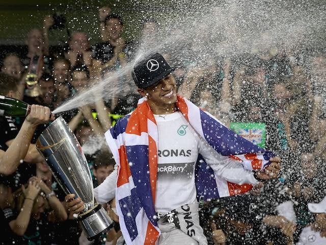 Lewis Hamilton of Great Britain and Mercedes celebrates after winning the Formula 1 World Championship at the Abu Dhabi Grand Prix on November 23, 2014