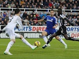 Newcastle United's Senegalese striker Papiss Cisse scores the opening goal past Chelsea's Belgian goalkeeper Thibaut Courtois during the English Premier League football match between Newcastle United and Chelsea at St James Park in Newcastle-Upon-Tyne, no
