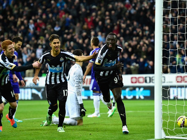 Papiss Cisse of Newcastle celebrates after scoring the opening goal during the Barclays Premier League match between Newcastle United and Chelsea at St James' Park on December 6, 2014
