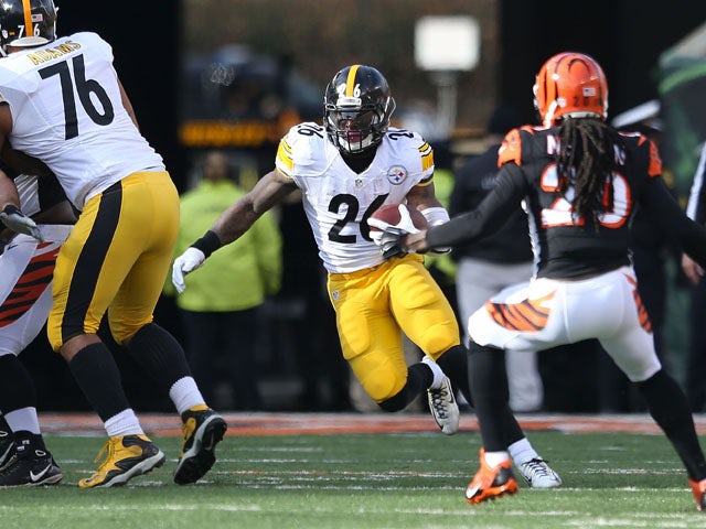 Le'Veon Bell #26 of the Pittsburgh Steelers attempts to run past Reggie Nelson #20 of the Cincinnati Bengals during the first quarter at Paul Brown Stadium on December 7, 2014