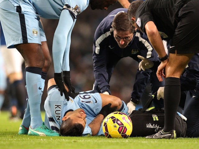 Manchester City's Argentinian striker Sergio Aguero lies injured during the English Premier League football match against Everton on December 6, 2014