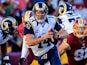 Quarterback Shaun Hill #14 of the St. Louis Rams scrambles to avoid the pressure of outside linebacker Ryan Kerrigan #91 of the Washington Redskins in the second quarter of a game at FedExField on December 7, 2014