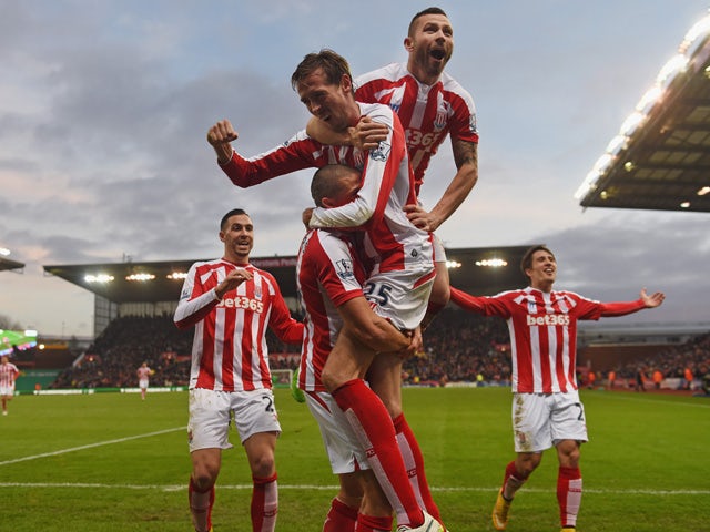  Jon Walters of Stoke is mobed by Phil Bardsley and Peter Crouch after scoring to make it 3-0 during the Barclays Premier League match between Stoke City and Arsenal at Britannia Stadium on December 6, 2014