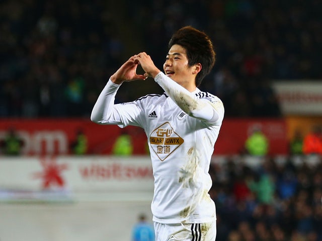Ki Sung-Yueng of Swansea City celebrates as he scores their first goal during the Barclays Premier League match between Swansea City and Queens Park Rangers at Liberty Stadium on December 2, 2014