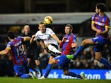 Christian Eriksen of Spurs shoots under pressure from Mile Jedinak and James McArthur of Crystal Palace during the Barclays Premier League match between Tottenham Hotspur and Crystal Palace at White Hart Lane on December 6, 2014