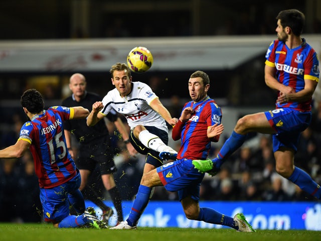 Christian Eriksen of Spurs shoots under pressure from Mile Jedinak and James McArthur of Crystal Palace during the Barclays Premier League match between Tottenham Hotspur and Crystal Palace at White Hart Lane on December 6, 2014