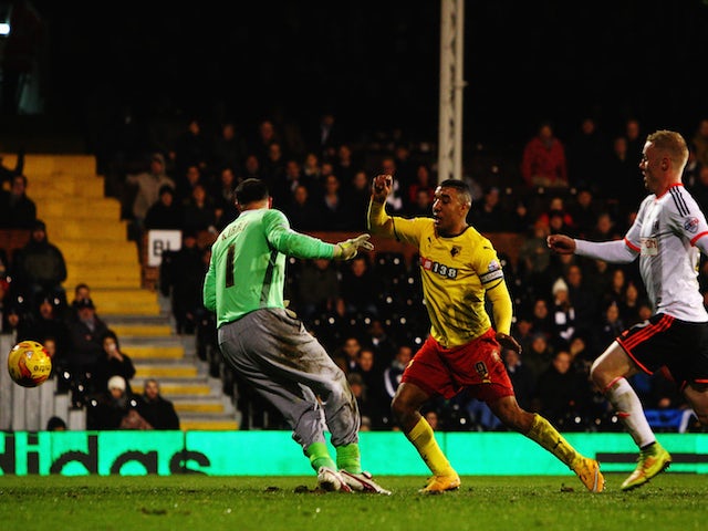 Troy Deeney (C) of Watford scores past Gabor Kiraly the Watford goalkeeper during the Sky Bet Championship match against Fulham on December 5, 2014