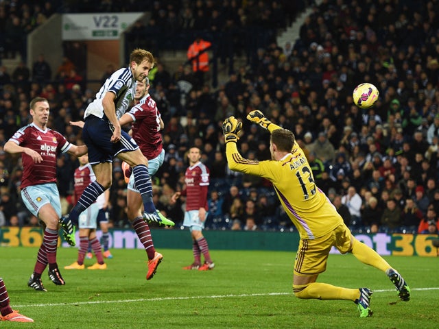 Craig Dawson of West Brom heads and scores the opening goal past Adrian of West Ham during the Barclays Premier League match between West Bromwich Albion and West Ham United at The Hawthorns on December 2, 2014