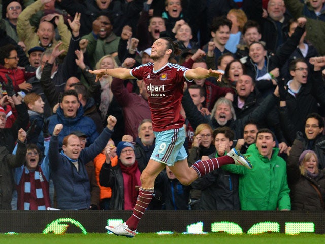 West Ham United's English striker Andy Carroll celebrates scoring their first goal to equalise during the English Premier League football match between West Ham United and Swansea City at the Boleyn Ground, Upton Park, in east London on December 7, 2014