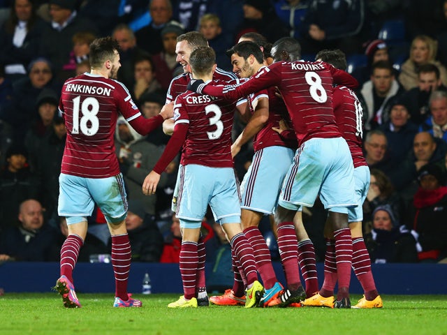 James Tomkins of West Ham United celebrates with team mates as he scores their second goal during the Barclays Premier League match between West Bromwich Albion and West Ham United at The Hawthorns on December 2, 2014