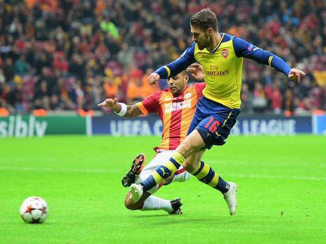 Aaron Ramsey of Arsenal (R) scores their second goal during the UEFA Champions League Group D match against Galatasaray on December 9, 2014