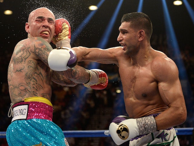 Amir Khan connects with a right at Luis Collazo during their welterweight bout at the MGM Grand Garden Arena on May 3, 2014